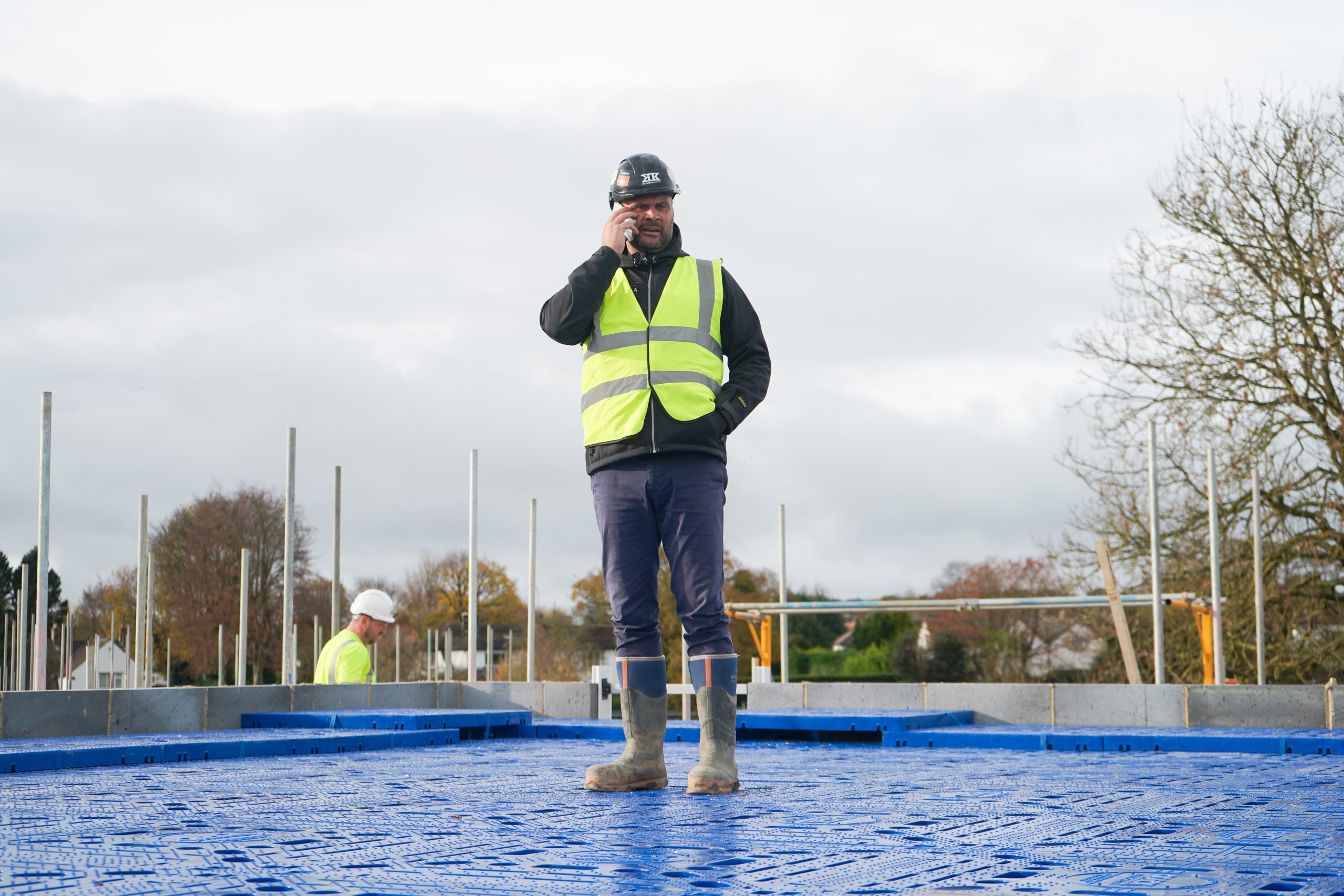 man standing on a fall protection system at a building site